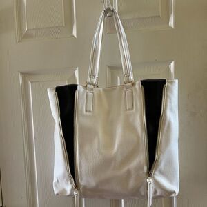 Aldo white and black large tote with gold tone zipper accents .